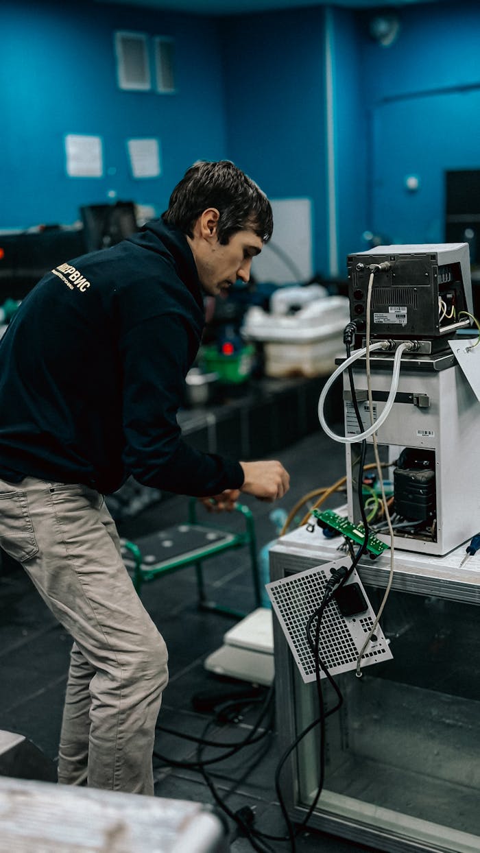 cta-02 A technician focused on repairing electronic equipment in a laboratory setting.